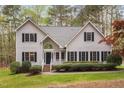 This two-story home features beautiful landscaping and a classic facade with black shutters at 537 Chatham Dr, Chapel Hill, NC 27516