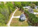 Aerial view of a spacious home with a long driveway surrounded by lush greenery at 5989 Zacks Mill Rd, Angier, NC 27501
