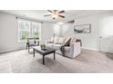 Bright living room featuring neutral decor, large windows, and comfortable seating at 5989 Zacks Mill Rd, Angier, NC 27501