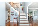 Inviting foyer features a staircase with wooden and wrought iron railings, and hardwood floors at 6020 Jones Farm Rd, Wake Forest, NC 27587