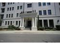 Close up of building entrance featuring pillars and landscaping at 620 Wade Ave # 206, Raleigh, NC 27605