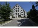 View of building with black framed windows and balconies, and well maintained sidewalk at 620 Wade Ave # 206, Raleigh, NC 27605