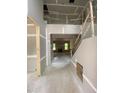 Unfinished foyer with staircase and visible doorway leading to other parts of the house at 70 Valebrook Ct, Youngsville, NC 27596