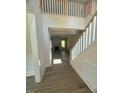 Bright foyer with hardwood floors, wooden staircase, and an open view to the living area at 70 Valebrook Ct, Youngsville, NC 27596