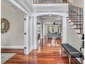 Grand foyer with gleaming hardwood floors, elegant staircase, and intricate architectural details at 76501 Rice, Chapel Hill, NC 27517