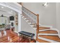 Elegant staircase with hardwood treads, decorative iron railings, and natural light at 76501 Rice, Chapel Hill, NC 27517