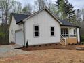 View showcases the home's charming exterior, highlighted by a convenient attached garage at 795 Terry Rd, Hurdle Mills, NC 27541