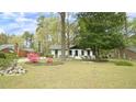 Beautiful one-story home with mature trees and blooming azaleas in a lush front yard at 909 Windcrest Rd, Durham, NC 27713