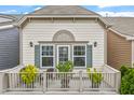 Upstairs balcony with plants and seating offers an inviting outdoor space at 989 Ambergate Sta, Apex, NC 27502