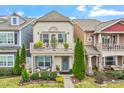 Charming two-story townhouse with a balcony, well-manicured lawn, and cozy front porch at 989 Ambergate Sta, Apex, NC 27502