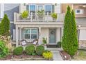 Cozy front porch with seating and a wreath on the door, leading to the home's entrance at 989 Ambergate Sta, Apex, NC 27502