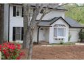 Traditional two-story home featuring white siding, black shutters, and a cozy bay window overlooking the landscaped front yard at 1003 Buckhorn Rd, Garner, NC 27529