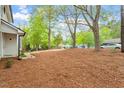Expansive front yard with mature trees leading up to a charming traditional home with a long driveway at 1003 Buckhorn Rd, Garner, NC 27529