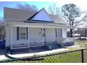 Inviting home showcasing a classic covered porch, with ample seating and fresh curb appeal at 10095 N Walnut St St, Middlesex, NC 27557