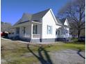 Lovely home displaying a spacious front porch, complemented by a well-manicured lawn at 10095 N Walnut St St, Middlesex, NC 27557