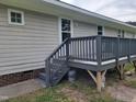 This home includes a dark gray wooden deck, accessible from the back of the house at 1033 Silas Moore Rd, Benson, NC 27504