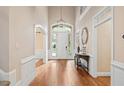Grand foyer with hardwood floors, detailed trim, and a elegant hanging light fixture at 10370 Spaight, Chapel Hill, NC 27517