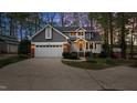 Charming two-story home showcasing manicured landscaping, a two-car garage, and a welcoming front entrance at 104 Stage Line Cv, Louisburg, NC 27549