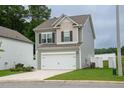 Charming two-story home features a two-car garage, well-maintained lawn, and white fence at 111 Flying Point Ln, Clayton, NC 27520
