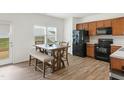 Eat-in kitchen with stainless appliances, wood cabinets, and room for a breakfast table at 111 Flying Point Ln, Clayton, NC 27520