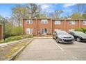 Brick townhome featuring muted purple shutters and a paved parking lot in a quiet setting at 116 Marlowe Court Ct, Carrboro, NC 27510