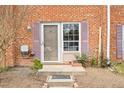 Inviting front entrance to the townhome with a storm door and lush, low-maintenance landscaping at 116 Marlowe Court Ct, Carrboro, NC 27510