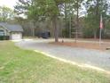 Long gravel driveway leading up to the home and garage at 126 Creedmoor Rd, Stem, NC 27581