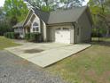 View of an attached garage, concrete driveway, and neatly landscaped yard at 126 Creedmoor Rd, Stem, NC 27581