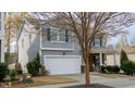 Two story home with light gray siding, dark shutters, a two car garage, and landscaping at 1620 Frog Hollow Way, Wake Forest, NC 27587
