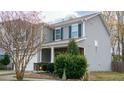 Two-story home with stone accents, a well-manicured lawn, and a welcoming front porch at 1620 Frog Hollow Way, Wake Forest, NC 27587