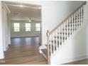 Elegant foyer with hardwood flooring, a staircase, and a view into a sunlit living area at 196 Golfview Ave, Benson, NC 27504