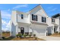 Charming two-story home with white siding, black shutters, and a spacious two-car garage at 196 River Bank Rd, Fuquay Varina, NC 27526