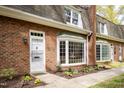 Attractive brick home with bay window, complemented by a well-maintained walkway and lush landscaping at 2 Banbury Ln # 2, Chapel Hill, NC 27517