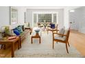 Bright living room with hardwood floors, a bay window, and stylish furnishings for a cozy atmosphere at 2 Banbury Ln # 2, Chapel Hill, NC 27517