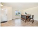Bright dining room featuring laminate flooring, a window and a dining table with seating for six at 211 Richmond Run, Stem, NC 27581