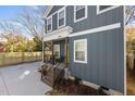 Gray home featuring a covered front porch with railings, complemented by fresh landscaping and a concrete driveway at 2207 Otis St # A, Durham, NC 27707