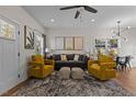 Stylish living room with hardwood floors, a ceiling fan, and two plush yellow armchairs at 2207 Otis St # A, Durham, NC 27707