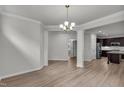 Open dining area leading to the kitchen with stylish columns and hardwood floors at 233 Stone River Dr, Wendell, NC 27591