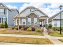 Charming home with stone accents, manicured landscaping, and inviting entryway at 233 Stone River Dr, Wendell, NC 27591
