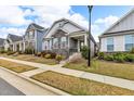 Charming home featuring stone accents, manicured landscaping, and a welcoming front porch at 233 Stone River Dr, Wendell, NC 27591