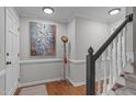 Bright entryway featuring hardwood floors, staircase, and stylish decor at 2629 Sweetgum Dr, Apex, NC 27539