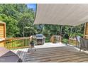 Outdoor deck with grill and canvas shade, ideal for entertaining and outdoor dining at 2832 Steeple Run Dr, Wake Forest, NC 27587