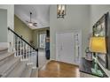 Open foyer showcasing hardwood floors, a white door, and a view into the living room at 2832 Steeple Run Dr, Wake Forest, NC 27587