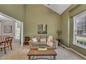 Cozy living room with neutral carpet, a comfortable couch, and large windows for natural light at 2832 Steeple Run Dr, Wake Forest, NC 27587