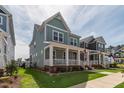 Inviting two-story home with a quaint front porch and lush green lawn at 304 Rivella Dr, Wake Forest, NC 27587
