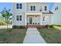 Welcoming front entrance with a brick-lined porch and a neatly landscaped yard, showcasing the home's curb appeal at 430 Wyndham Dr, Chapel Hill, NC 27516