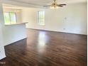 Spacious living room with dark hardwood floors, bright natural light, and open concept layout at 4616 Silverdene St, Raleigh, NC 27616