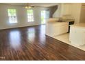 Inviting living room with hardwood floors next to the bright kitchen and a large window at 4616 Silverdene St, Raleigh, NC 27616
