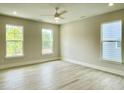 Bright bedroom with light gray walls, modern ceiling fan, and hardwood flooring at 486 Traditions Grande Blvd # 28, Wake Forest, NC 27587