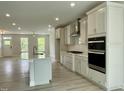 Modern kitchen featuring white cabinets, a large island with seating, stainless steel appliances, and plenty of counter space at 486 Traditions Grande Blvd # 28, Wake Forest, NC 27587